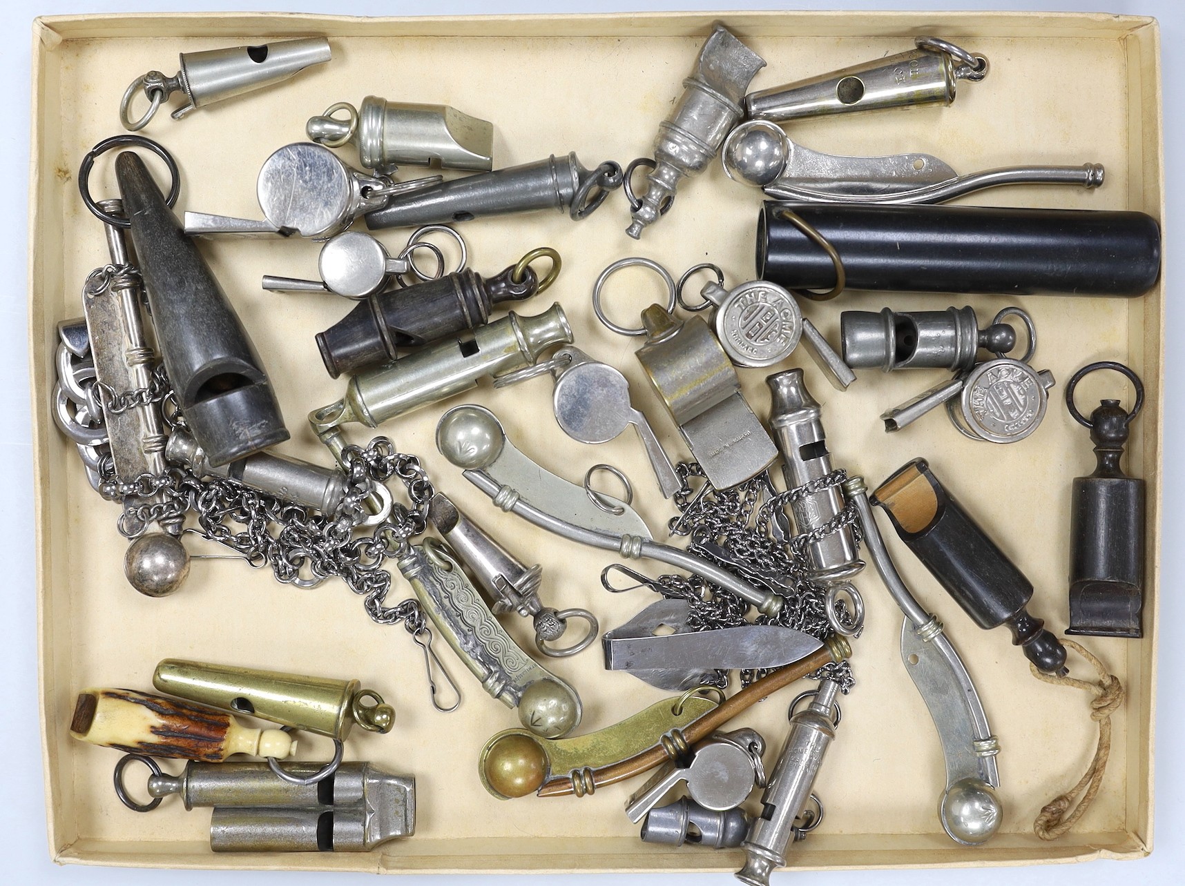 A large collection of 19th/20th century plated, nickel or horn whistles and two cut steel chatelaines, including two rifle brigade whistle, chain and lion mask, boson’s whistles ACME etc.